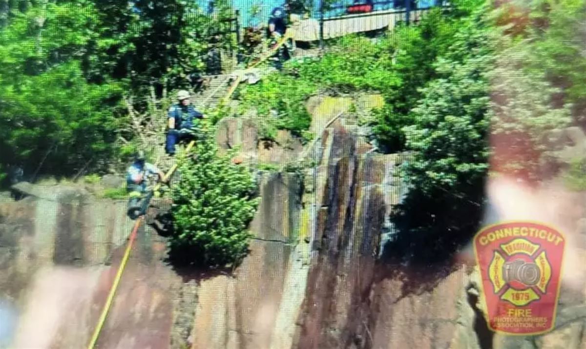 Firefighters lower rope from East Rock Top